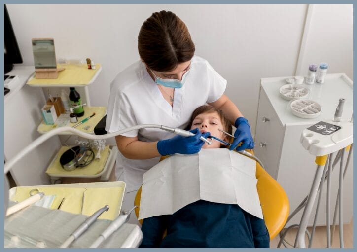 Close-up of a dentist applying a dental sealant to a child's molar, highlighting the protective coating being placed on the tooth's surface to prevent cavities.