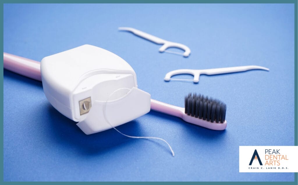 Dental floss, floss picks, and a toothbrush neatly arranged on a clean surface for oral hygiene.