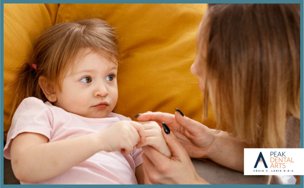 Happy mother playing with her young daughter at home, bonding and smiling together