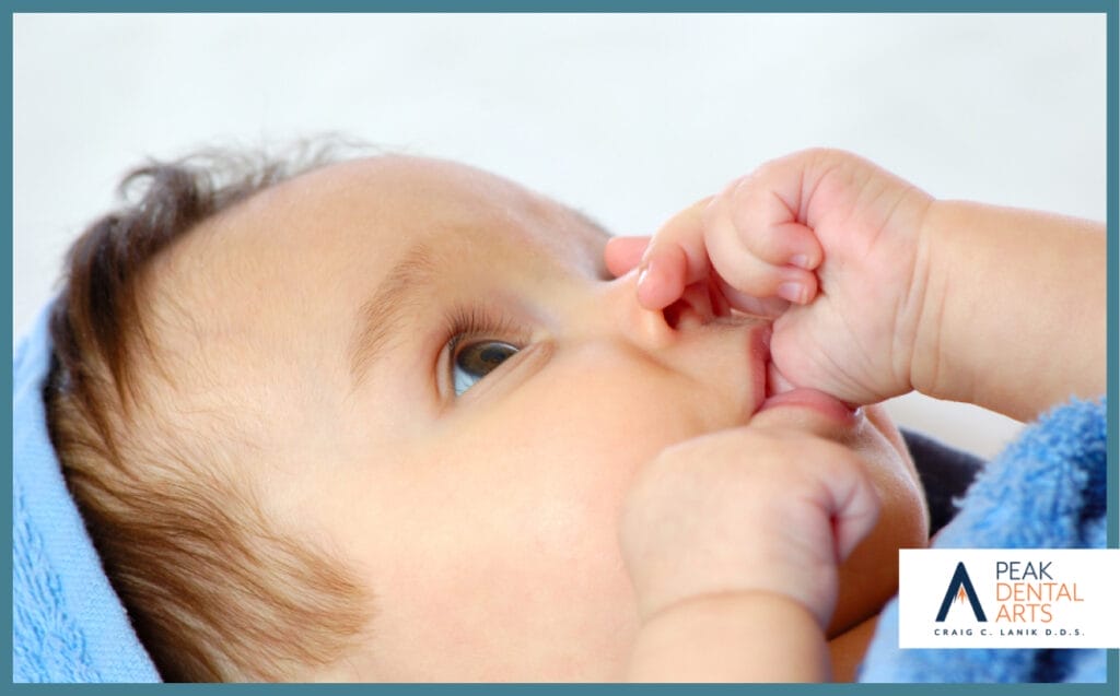 Close-up of a baby sucking their thumb, showing natural self-soothing behavior